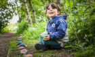 The Courier, CR0021700, News, Emma Crichton story, Harry Boa, the lockdown snake made of painted stones at Forfar Loch. Picture shows; Isaac Herd, 4, with the snake. Friday 5th June, 2020. Mhairi Edwards/DCT Media