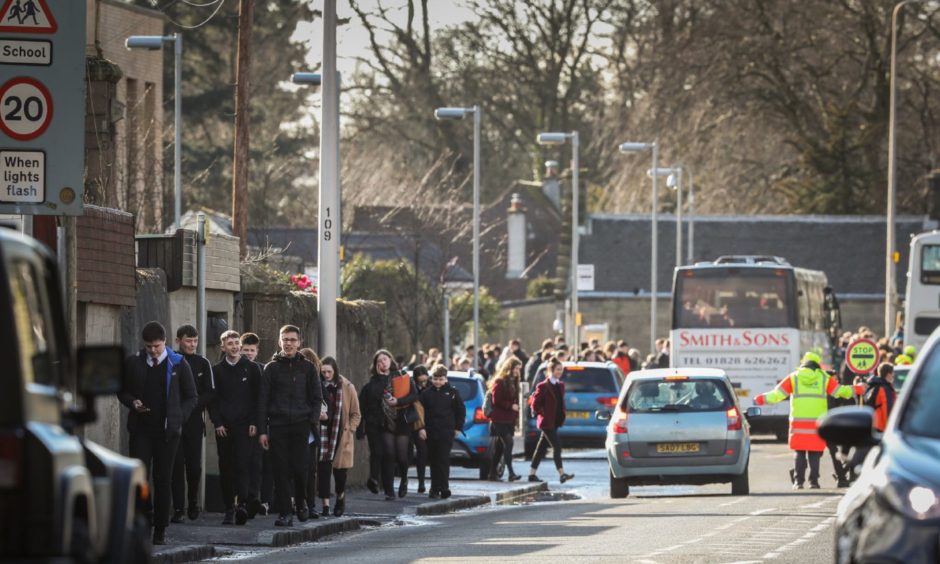 Pupils leave a local school at the beginning of the coronavirus pandemic.