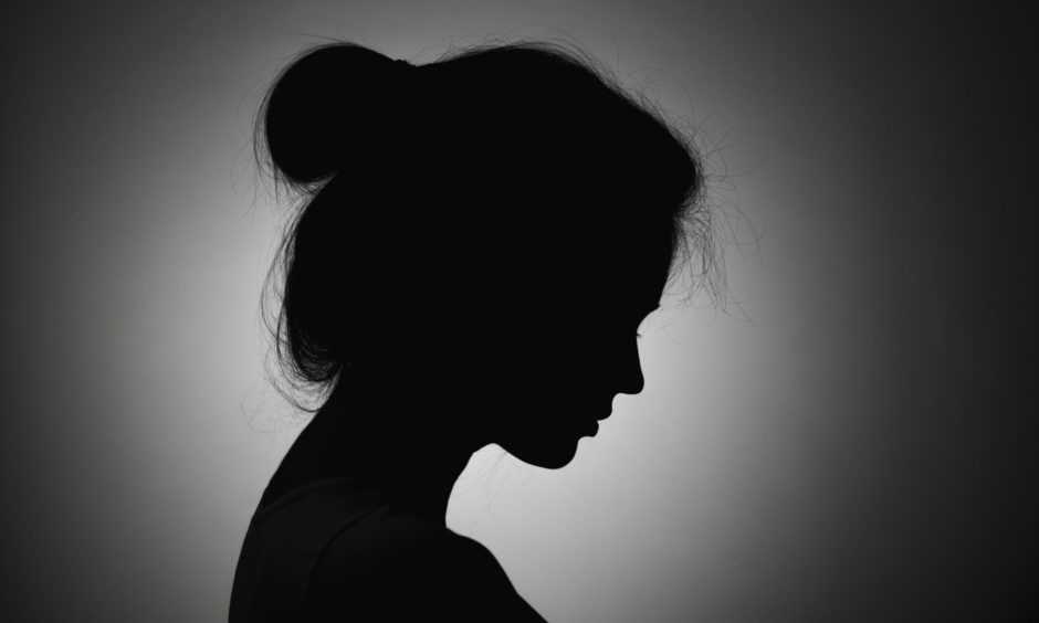 The silhouette of a young woman