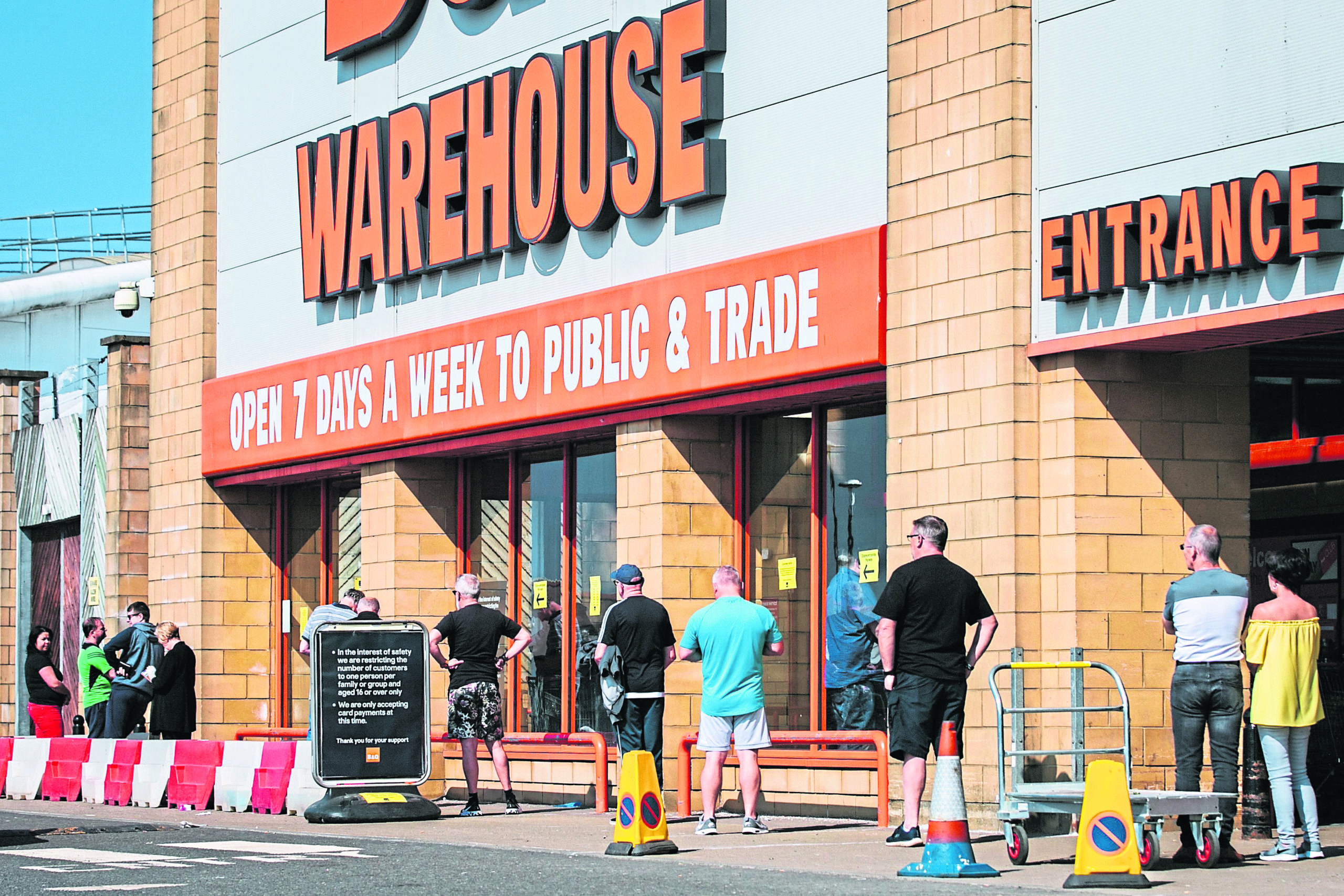 Shoppers observe social distancing as they queue outside B&Q.