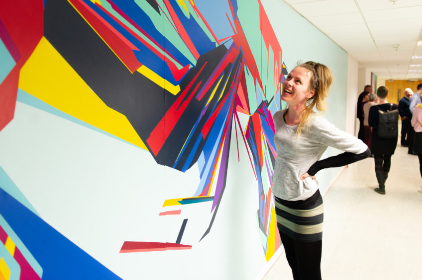 Artist Joanna Craig and her artwork, part of a project to illustrate the story of NCR in Dundee.