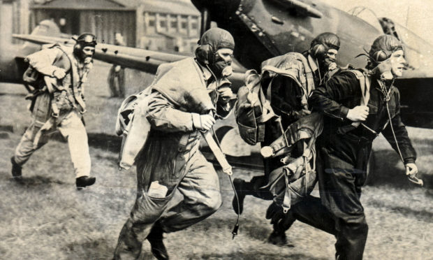 RAF Spitfire fighter pilots scramble to get airborne during the Battle of Britain.