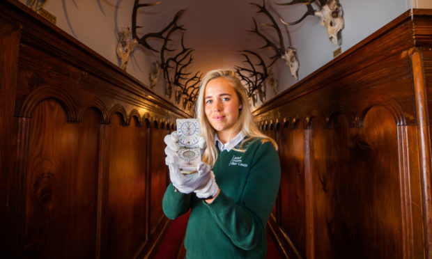 Chloe Thorton holding Bonnie Prince Charlie's compass