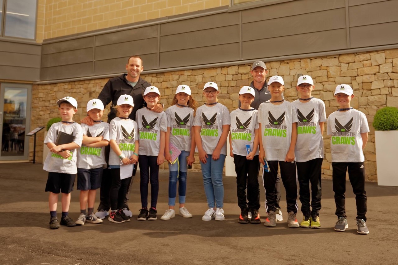 Carnoustie Craws youngsters during the 2018 Open Championship with star players Sergio Garcia and Rory McIlroy.