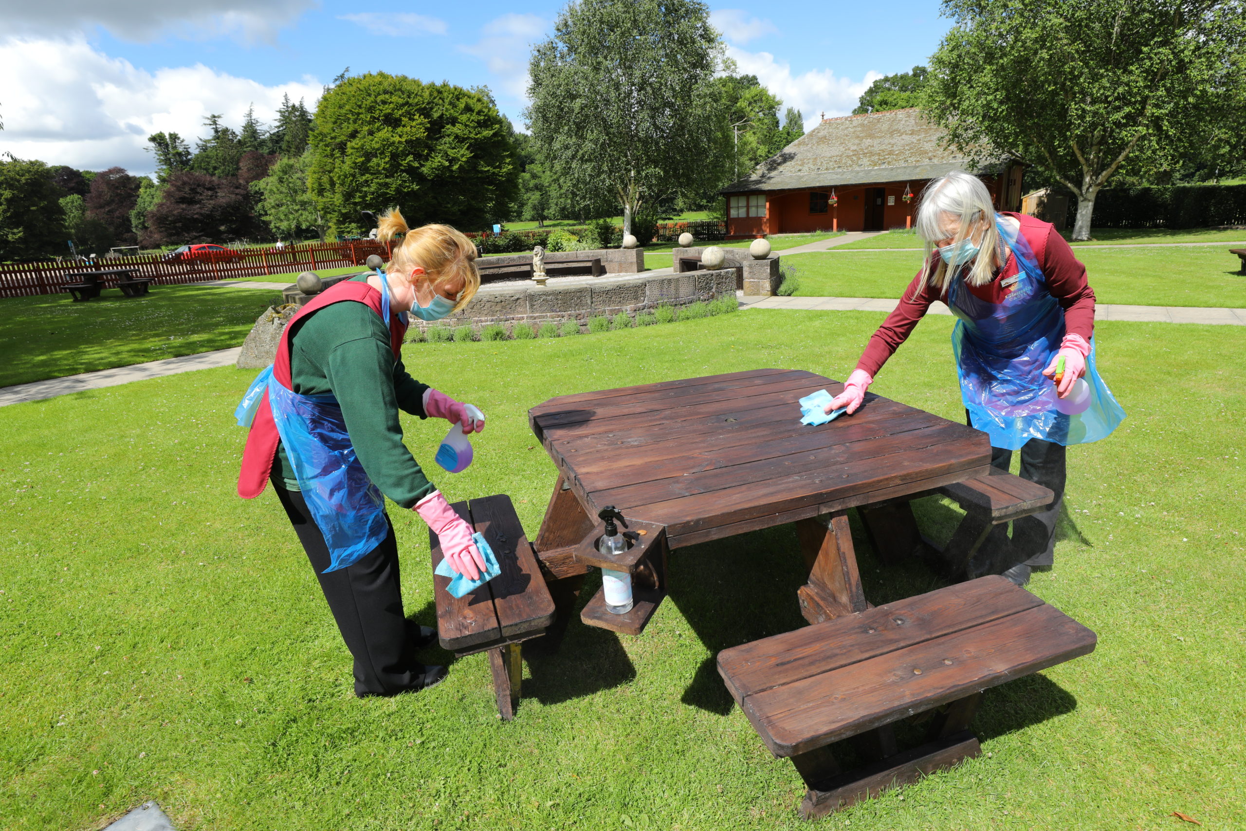 Cleaners Jamie Sheilds, left, and Wendy Greenhill wiping down one of the picnic benches at Glamis Castle.