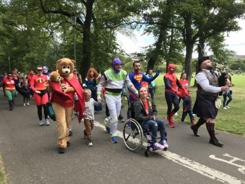 The Fife superheroes are piped in through the Meadows before arriving at the Sick Kids Hospital.