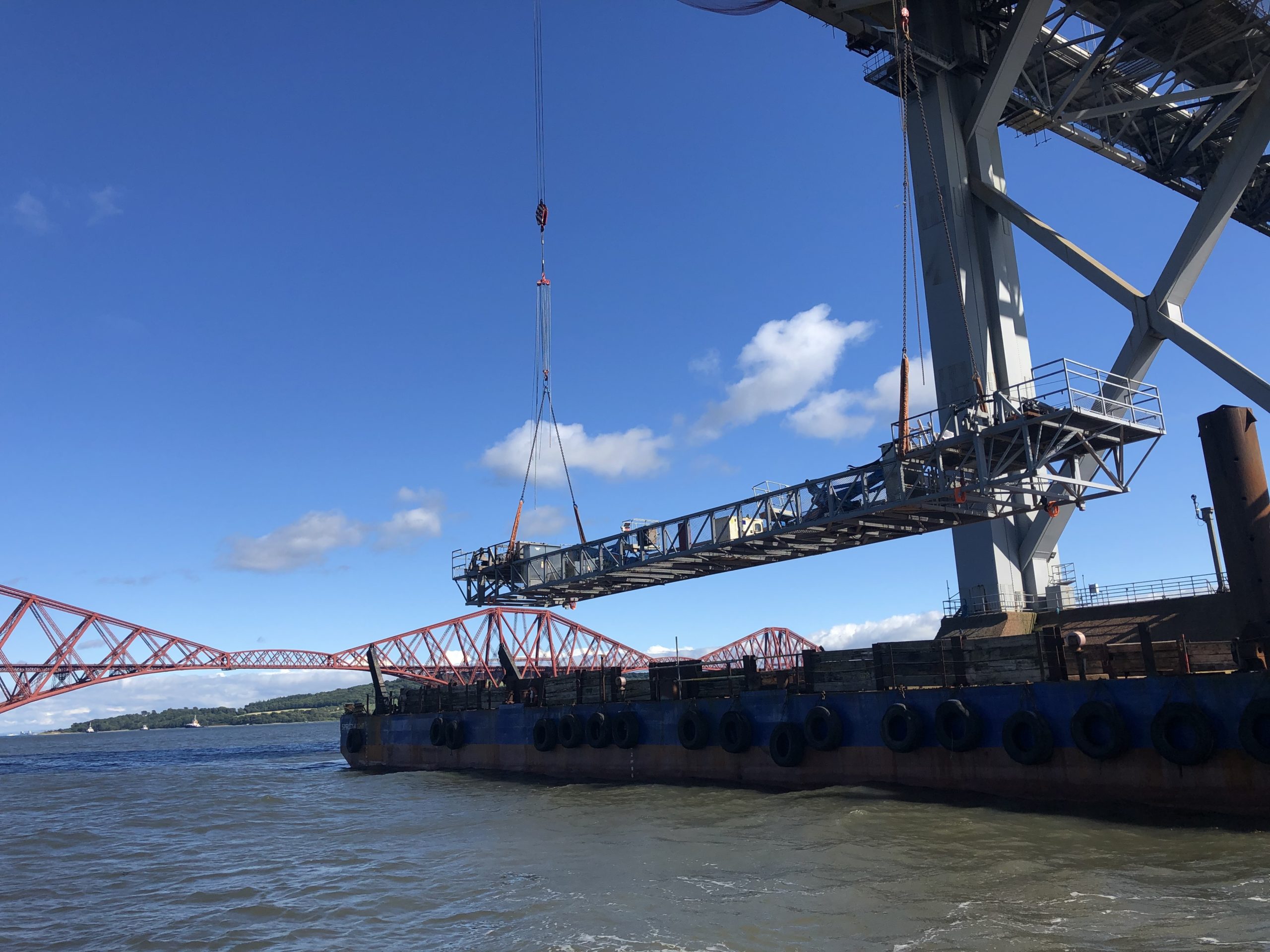 The huge gantries have been lowered by crane on to barges below.