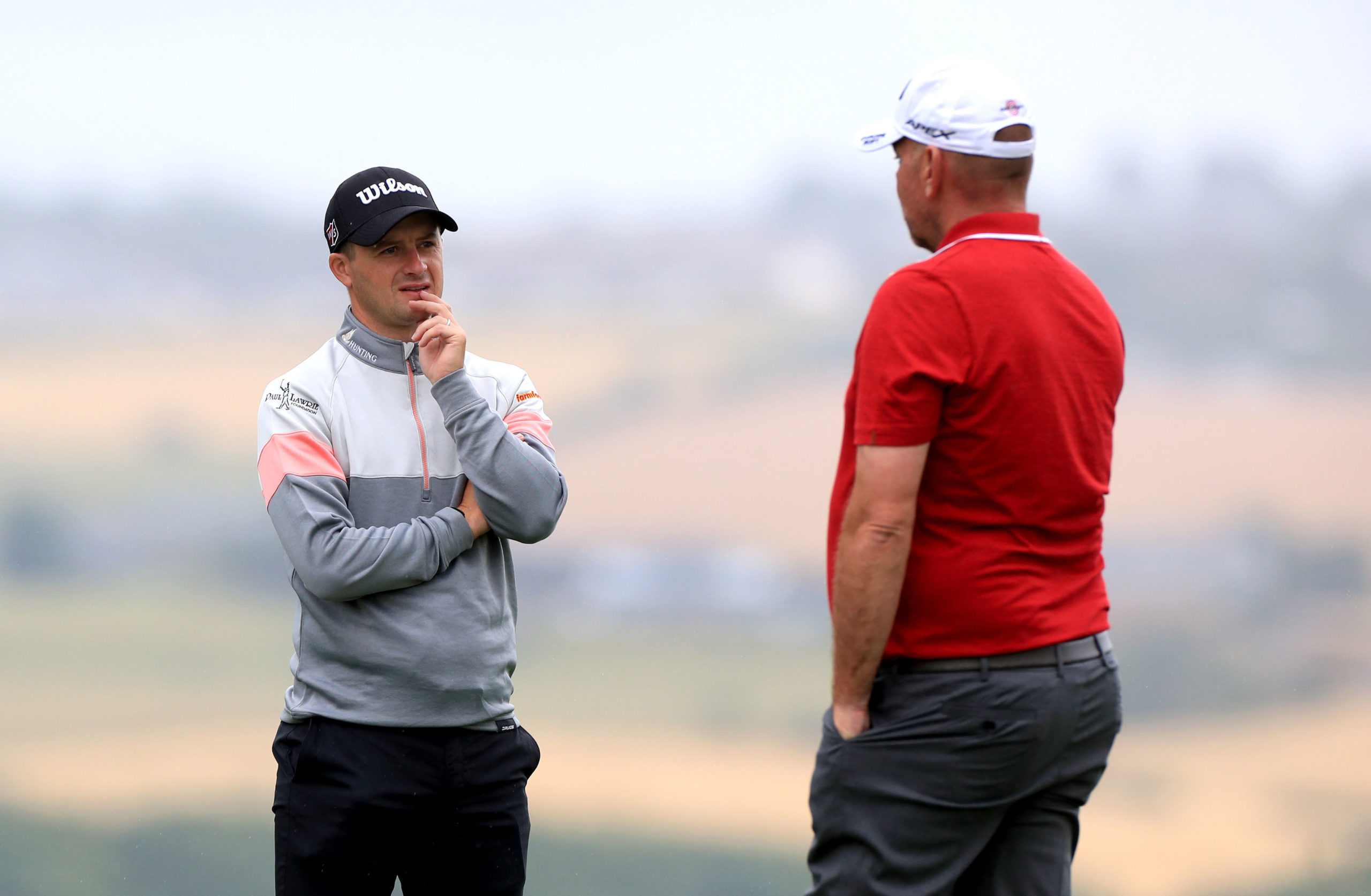 David Law has a socially-distanced chat with Ryder Cup skipper Thomas Bjorn during play at Close House.