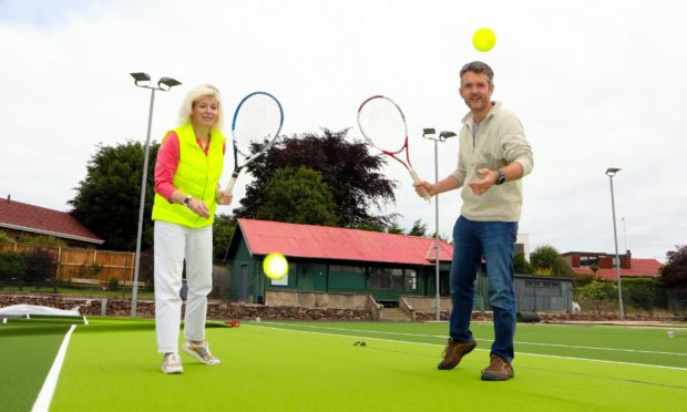 Club president Amanda Barclay and member Colin Birtwistle on the new courts as the project nears completion.