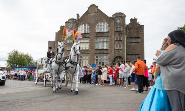 The horse-and-carriage pass Clepington Primary School.