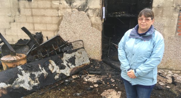 Susan Vines, a member of the club's management team with some of the fire damage.
