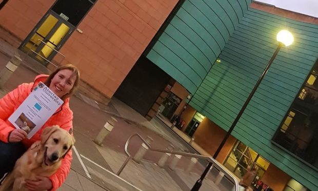 Lisa Halley at Abertay University with her guide dog, Jumble.