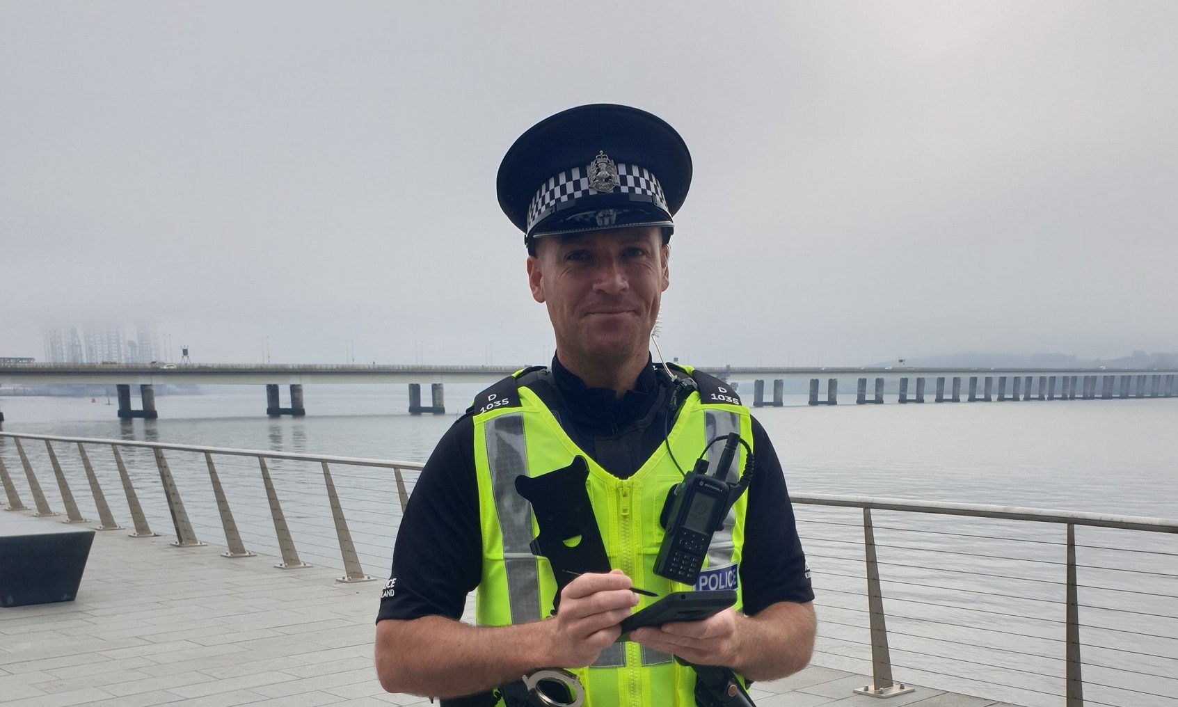 Tayside-based PC Garrie Watson using a mobile device