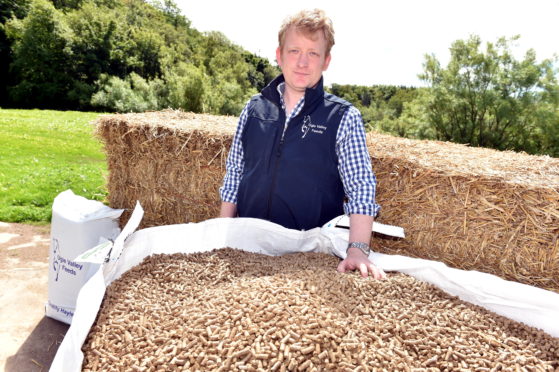 Ugie Valley Feed’s Fraser Mackintosh at the machine that produces the pellets.