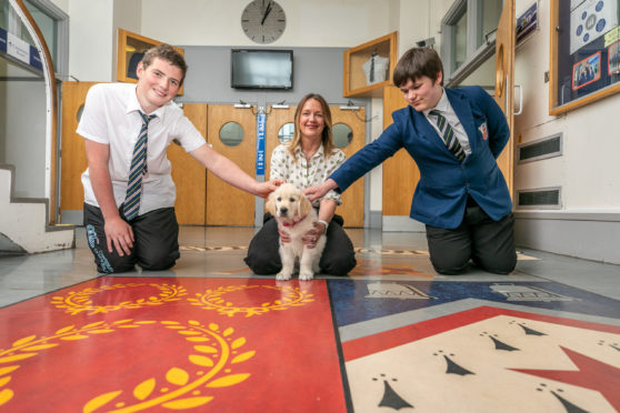 Bella with rector Carol Ann Penrose and pupils Callum Christie and Logan Fenton.