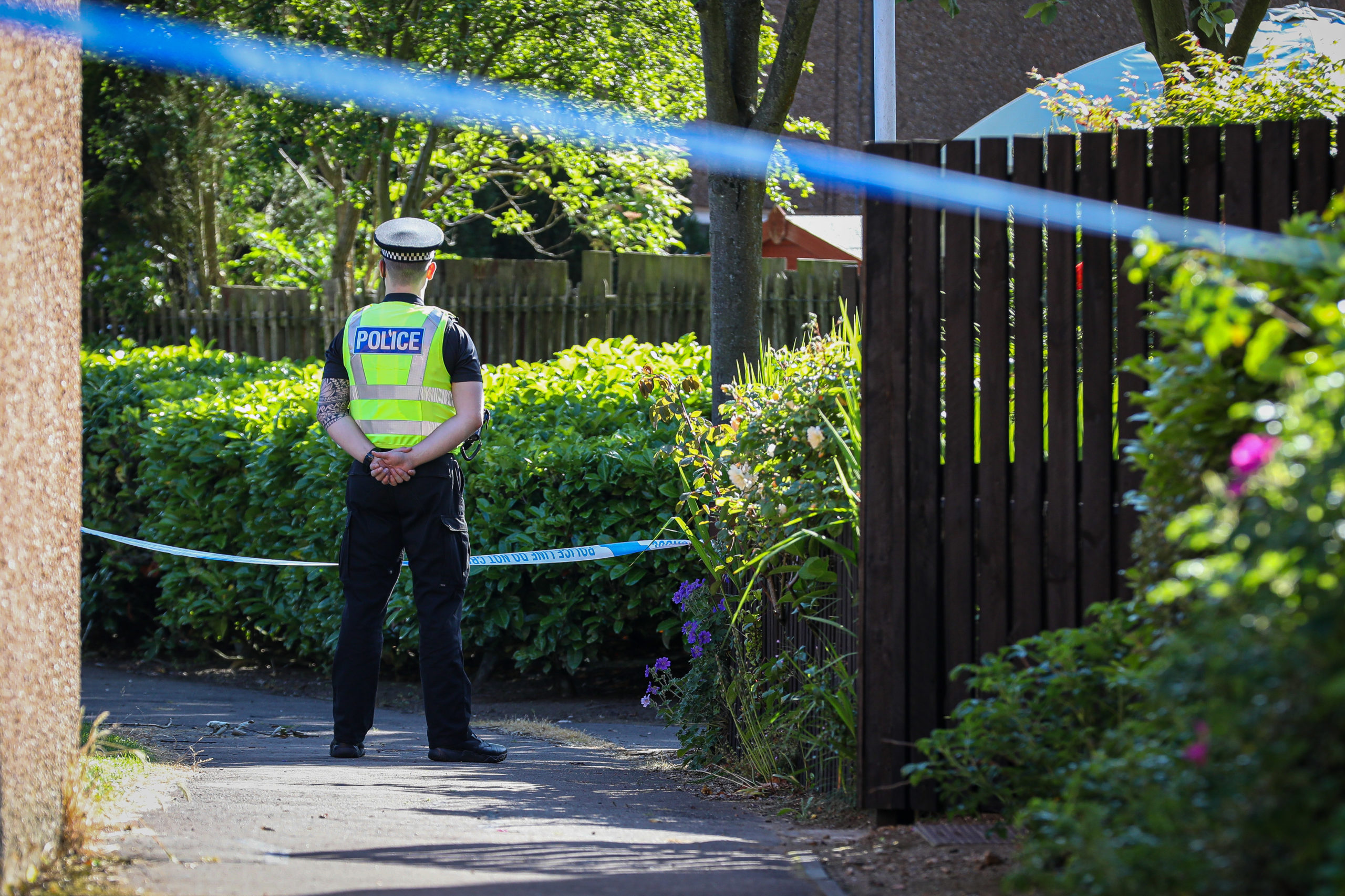 An officer guards the property in Meldrum Gardens, Glenrothes where the 83-year-old was attacked.