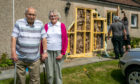 Mr and Mrs Pryde outside their damaged house.