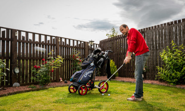 Robert getting into the swing in his back garden.