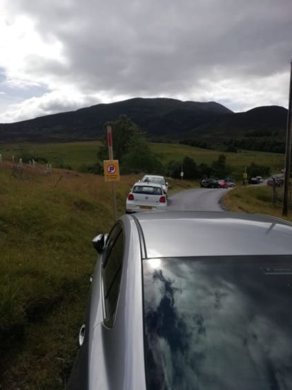 Tourists ignored 'no parking' signs near Schiehallion car park, near to Braes of Foss Farm, during walking season in 2020.