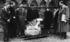 A group of local officials inspect the Stone of Destiny at Arbroath Abbey in 1951.