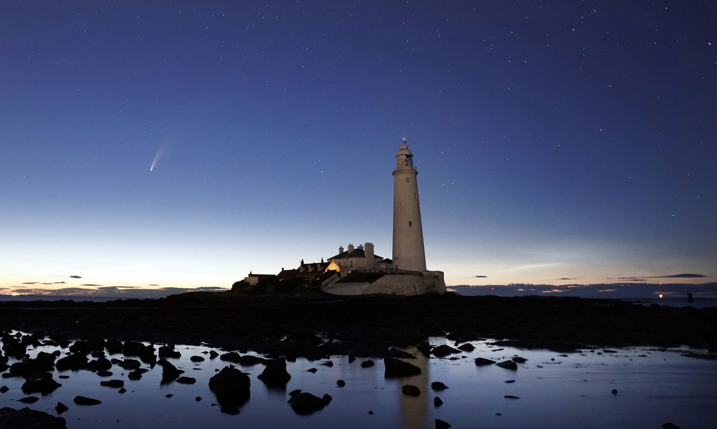 Comet Neowise passes St Mary's Lighthouse in Whitley Bay in the early hours of Tuesday morning. PA Photo. Picture date: Tuesday July 14, 2020. Photo credit should read: Owen Humphreys/PA Wire