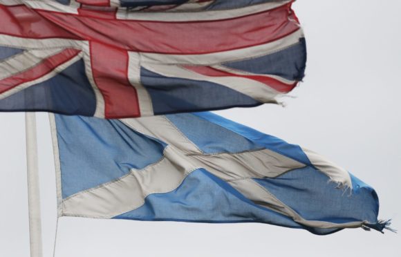 File photo from 2014 of a Union Flag and Saltire Flag. Dundee City Council leader, John Alexander, will write to Prime Minister Rishi Sunak asking the UK government to "work urgently" with the Scottish government towards a second referendum.  Danny Lawson/PA Wire