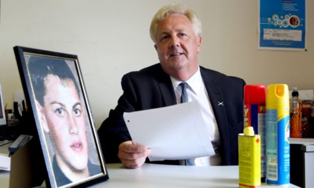 John O'Brien beside a picture of his son Lee.