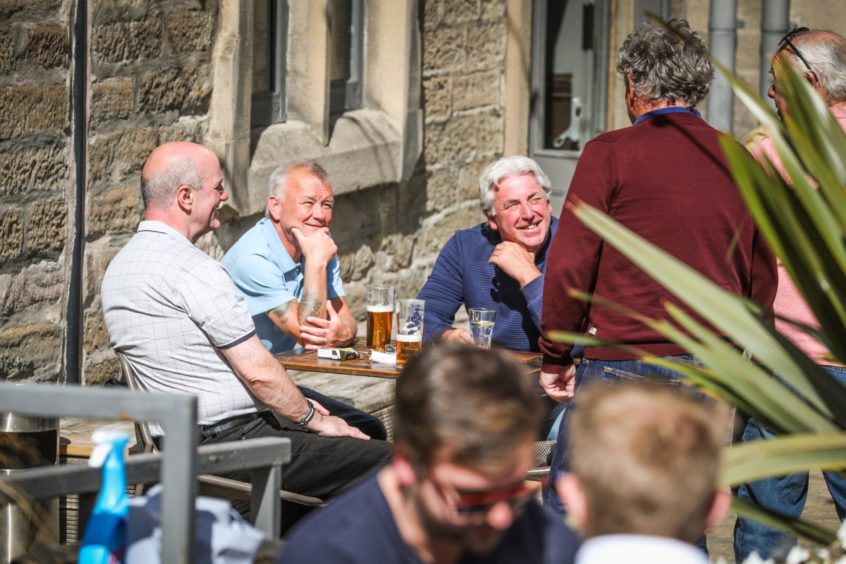 Customers catching the sun in the beer garden at Duke's Corner