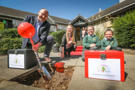 East Fife Joinery's Murray Dunsire with Niamh Anderson, 15, and brothers Jaiden, 11, and Rease, 7, Morrison with the time capsules.