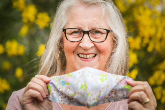 Glamis woman Julia Richards has raised £1000 for Whitehills Health and Community Care Centre by making masks for villagers. Picture shows; Julia Richards with some of her masks. Wednesday 8th July, 2020. Mhairi Edwards/DCT Media