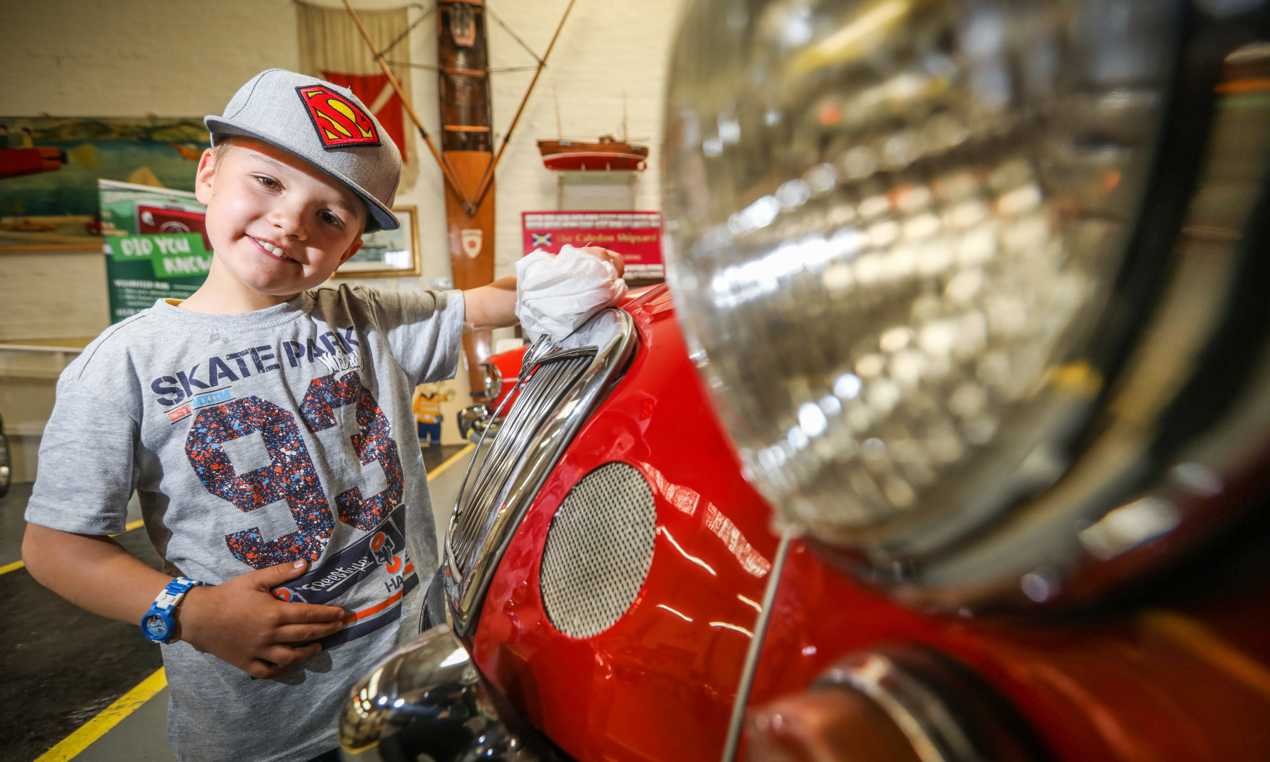 The Courier, CR0022410, News, Graham Brown story, Dundee Museum of Transport re-opens after four months due to Covid-19. Picture shows; Christopher Bieda, 7, shines one of the cars in the museum. Wednesday 15th July, 2020. Mhairi Edwards/DCT Media