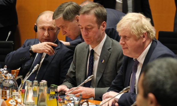 St Andrews University expert Professor Phil O'Brien says Russian President Vladimir Putin, left, sees weakening the Western alliance as being in his interest.