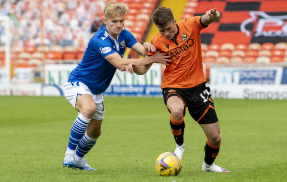 Saints' Ali McCann and United's Jamie Robson wrestle for the ball.