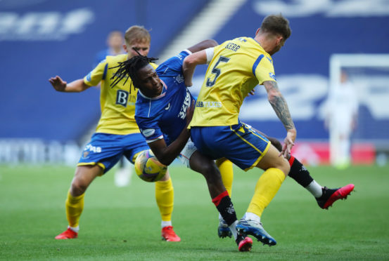 Saints' Jason Kerr challenges Joe Aribo of Rangers.