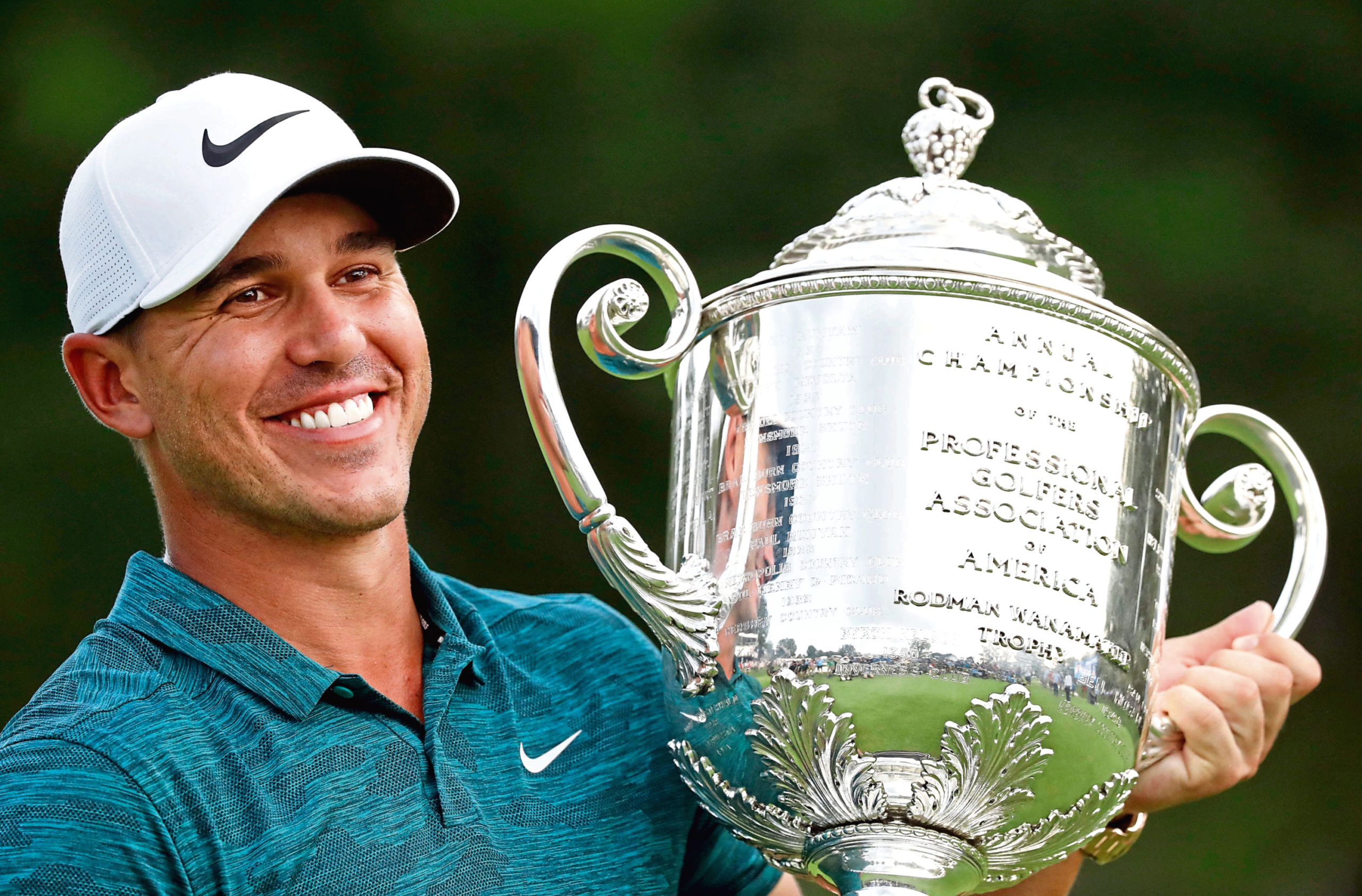 Brooks Koepka holds the Wanamaker Trophy after he won the PGA Championship golf tournament at Bellerive Country Club, Sunday, Aug. 12, 2018, in St. Louis. (AP Photo/Brynn Anderson)