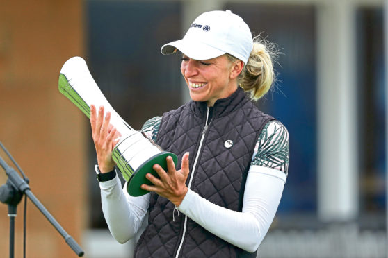 Popov
TROON, SCOTLAND - AUGUST 23: Sophia Popov of Germany lifts the trophy following the final round during Day Four of the 2020 AIG Women's Open at Royal Troon on August 23, 2020 in Troon, Scotland. (Photo by R&A - Handout/R&A via Getty Images)