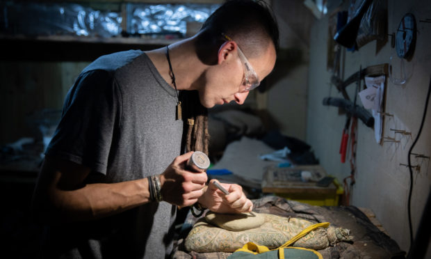 Stone carver Dean Gowans of Stravaig Stonecraft with his work.