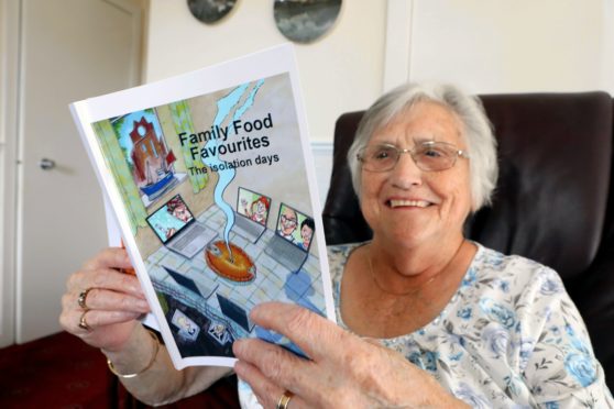Marie Welsh of the Local People Project with the Family Food Favourites recipe book.