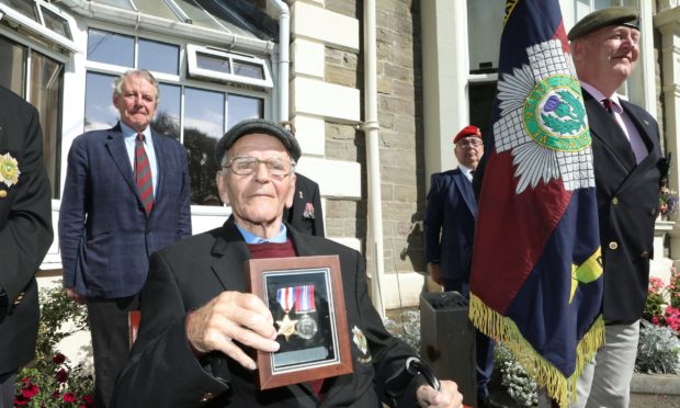 Gordon Webster with the  medals.