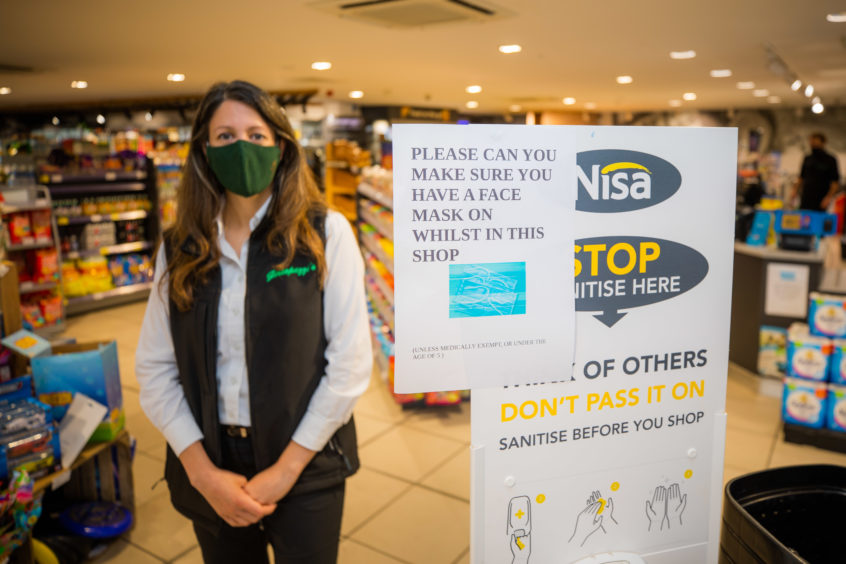 Kinross store owner Joanna Casonato wearing her mask.