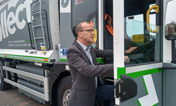 Councillor Mark Flynn with the Dennis Eagle electric bin lorry.