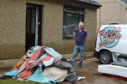Robert Norrie, 52, clearing out his flood damaged home at Burnside Cottages.