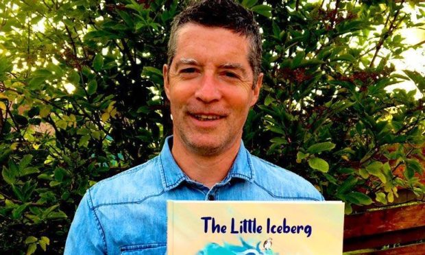 Nicky Murray with his book, The Little Iceberg.