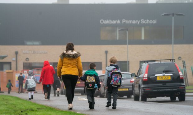 Pupils arriving at Oakbank Primary School, where one child tested positive for Covid-19 after the summer break.