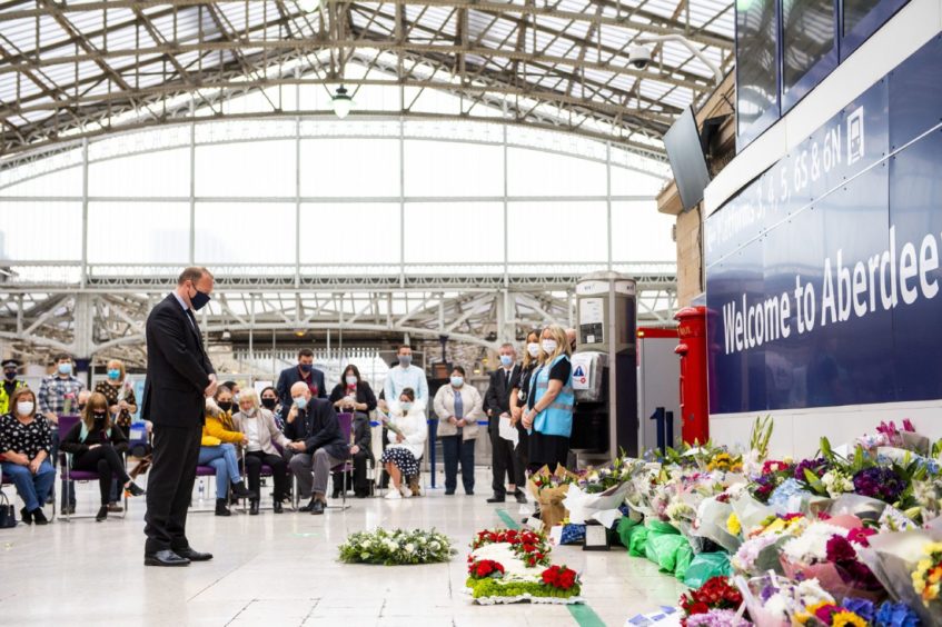 ScotRail Managing Director Alex Hynes lays a wreath at Aberdeen Train Station one week since the Stonehaven train derailment which killed three people.