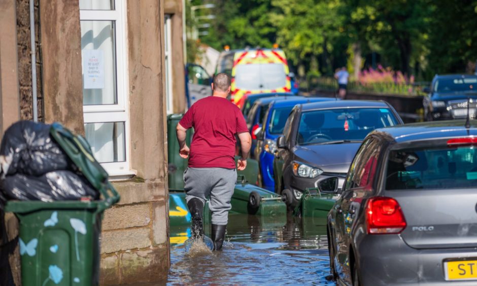 Mark Ritchie, South Inch Terrace resident making his way through the flood.