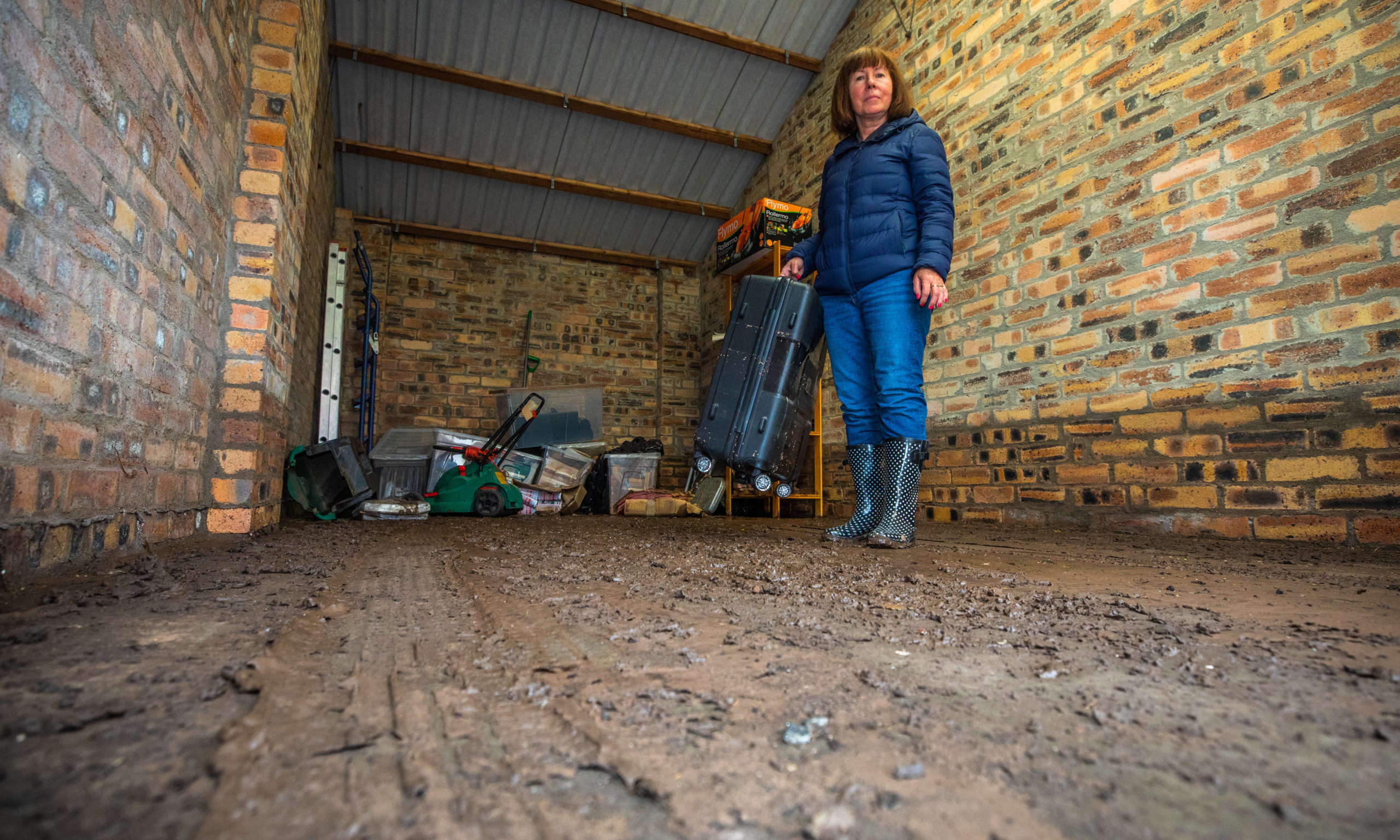 Patricia Duncan alongside some of the flood damaged contents in her Balmoral Place lockup.