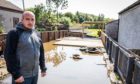 Cardenden resident Chris King surveys the damage caused by the flood water to his property in August 2020.