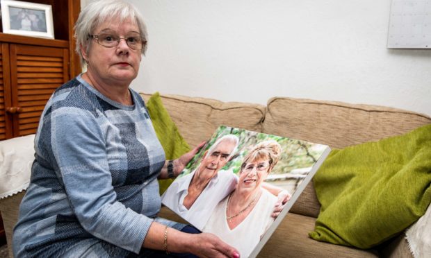 Sally with a picture of her mum Rae and her late father.