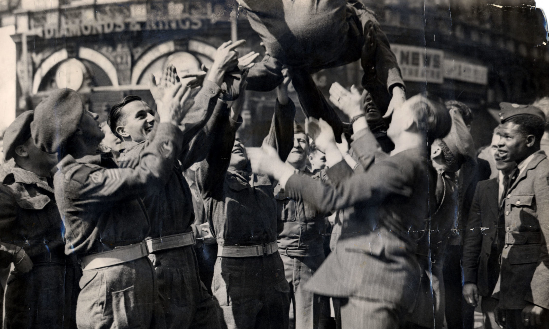Soldiers celebrating Victory over Japan in Piccadilly Circus, London.